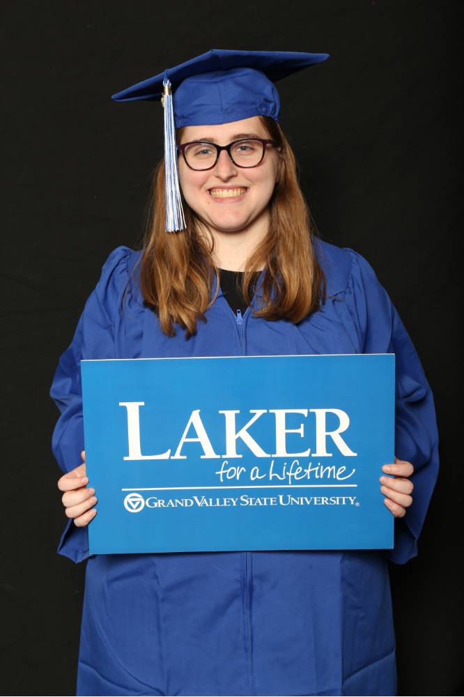 laker in cap and gown holding laker for a lifetime sign